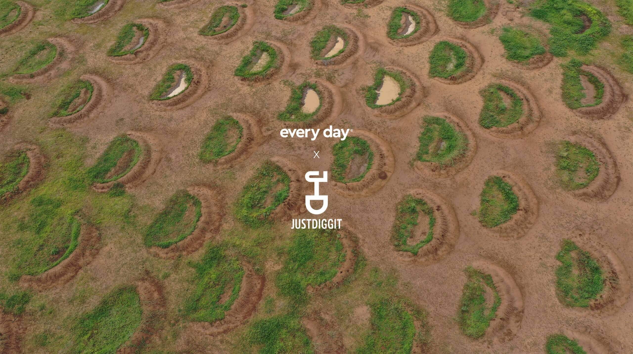 Luchtfoto: Droog terrein bezaaid met groene halve manen en plassen. Tekst: "Every Day" met een scheppictogram.
