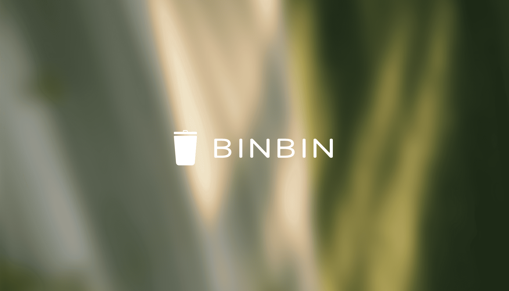 Wit prullenbakpictogram en "BINBIN" op een wazige groene en beige achtergrond.